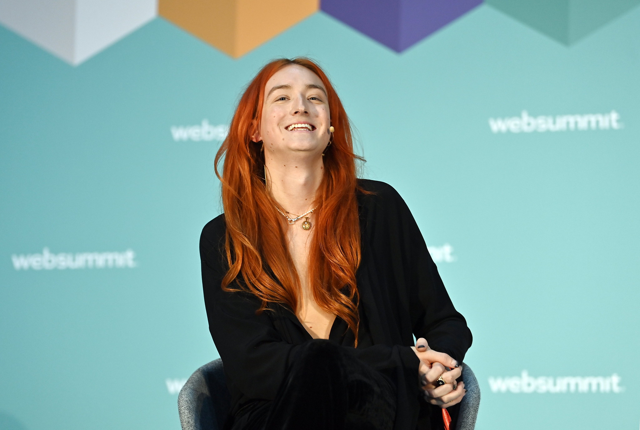 A photograph of a person (Harris Reed, ZEO of Edelman) speaking on the Corporate Innovation Summit stage at Web Summit. The person appears to be smiling.