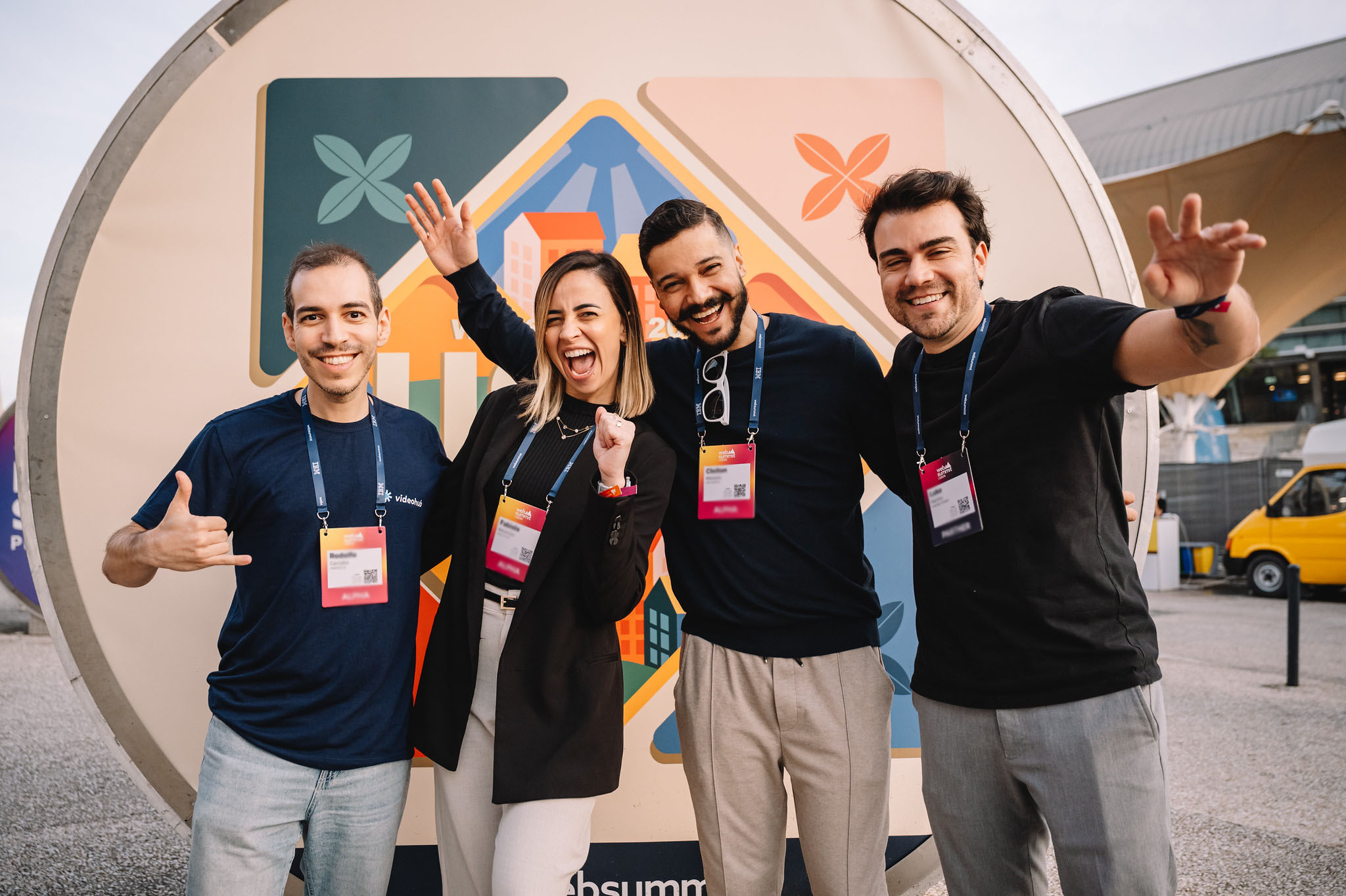 Group of four attendees smiling at the entrance of Web Summit