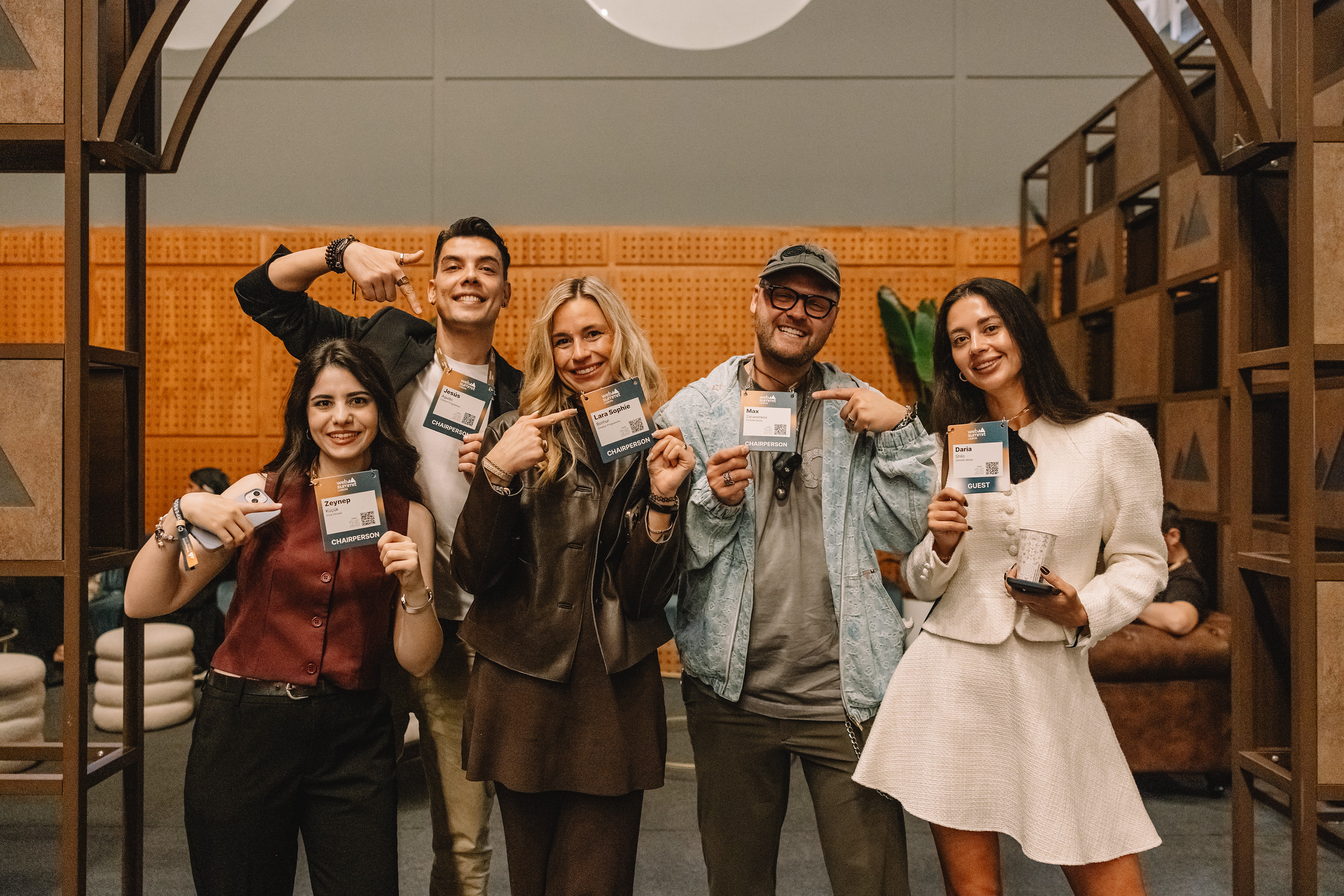 Five guests smiling and holding their landyards at the Web Summit Speaker Lounge